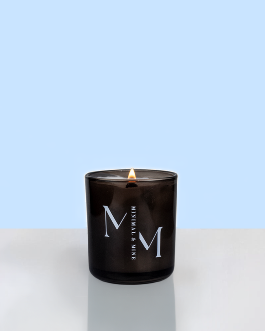 Bahamas Promises Candle Jar in sleek black glass, hand poured with coconut natural soy wax and lit, showcasing vibrant summer vibes.