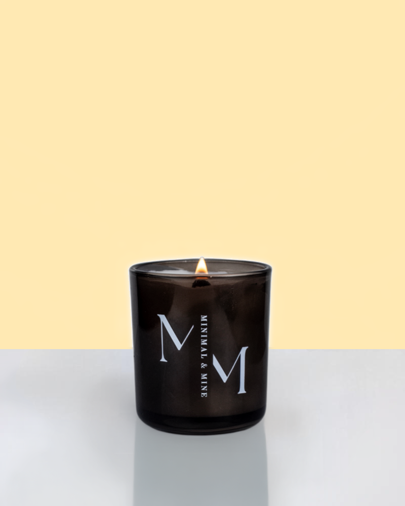 Beach Please Candle Jar in sleek black glass, hand poured with natural coconut soy wax and lit, showcasing vibrant summer vibes.
