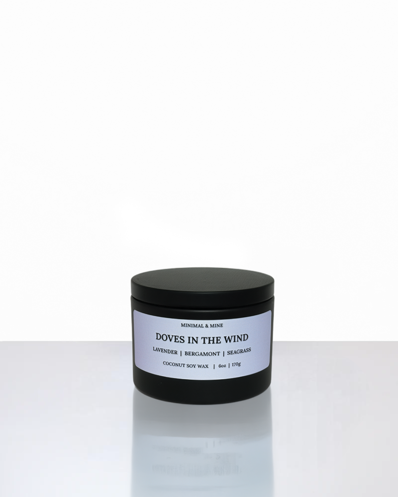 Candle jar labeled 'Doves in the Wind' on a white background