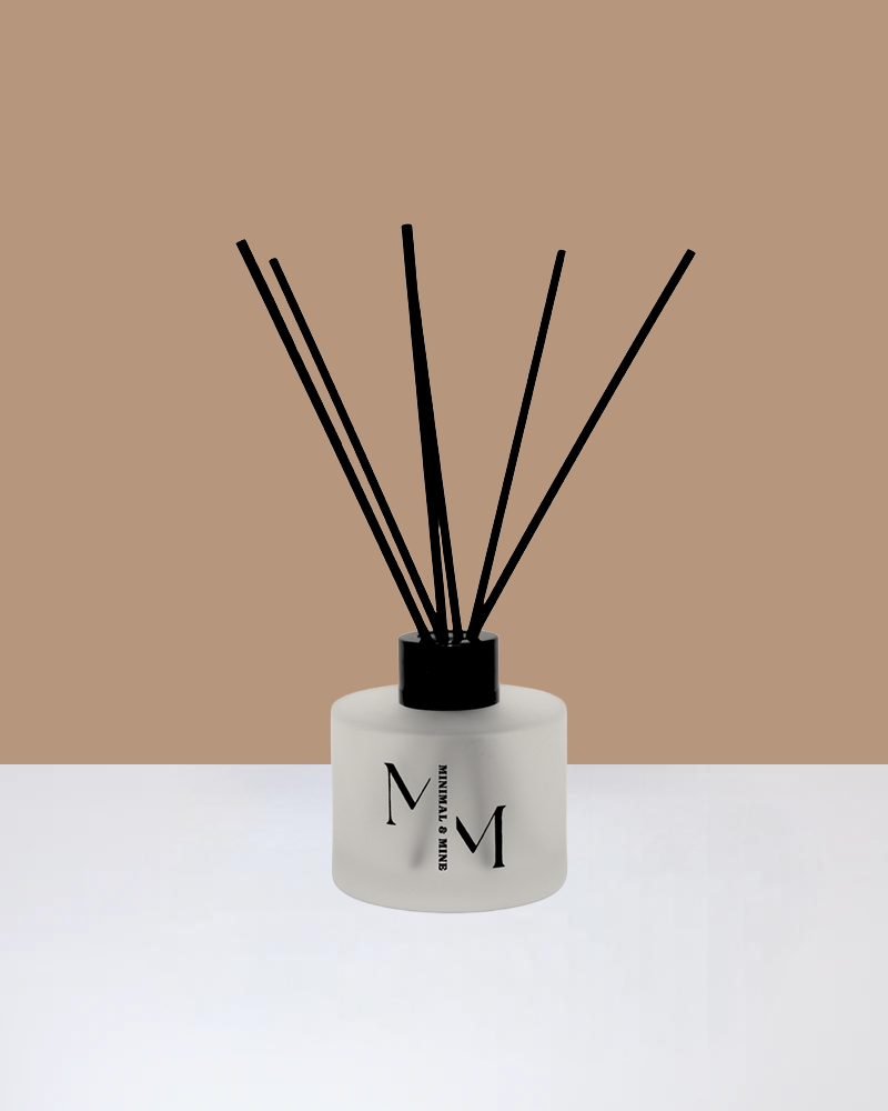 BLACK VANILLA REED DIFFUSER with black reeds in an elegant frosted glass bottle.