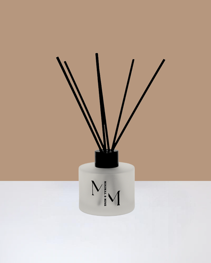 BLACK VANILLA REED DIFFUSER with black reeds in an elegant frosted glass bottle.