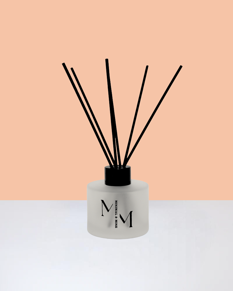 PEACHES REED DIFFUSER in a sleek glass bottle with natural reeds for a fruity scent.