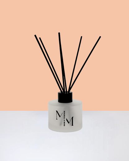 PEACHES REED DIFFUSER in a sleek glass bottle with natural reeds for a fruity scent.