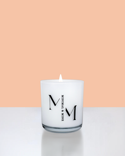 Peaches Candle Jar in sleek white glass, hand poured with natural soy wax and lit, showcasing vibrant summer vibes.