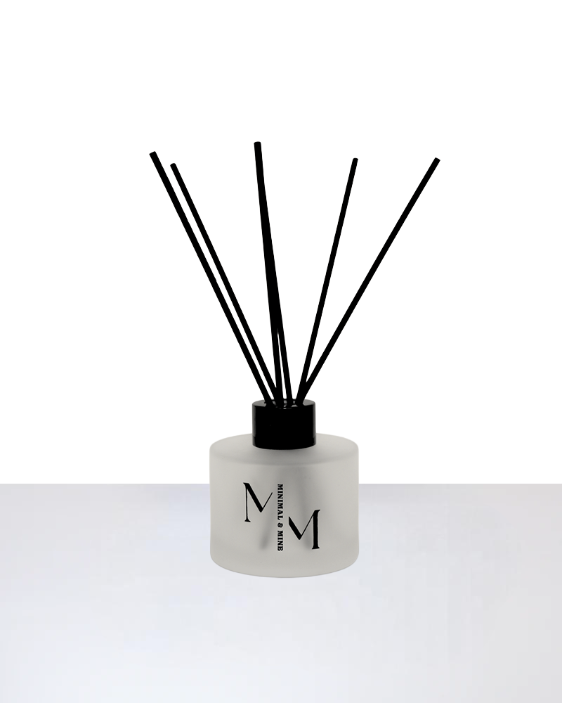 SUNDAY REED DIFFUSER with black reeds in a frosted glass bottle for a fresh scent experience.