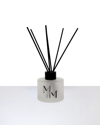 SUNDAY REED DIFFUSER with black reeds in a frosted glass bottle for a fresh scent experience.
