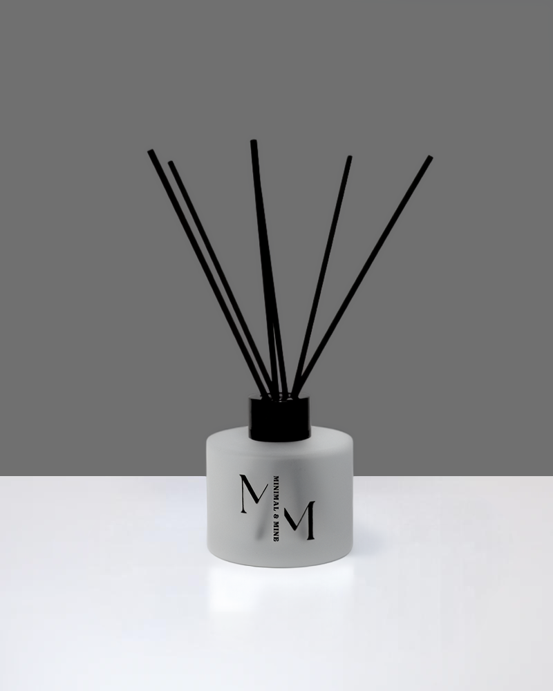 Stylish TUXEDO REED DIFFUSER with black reeds in a sleek frosted glass container.